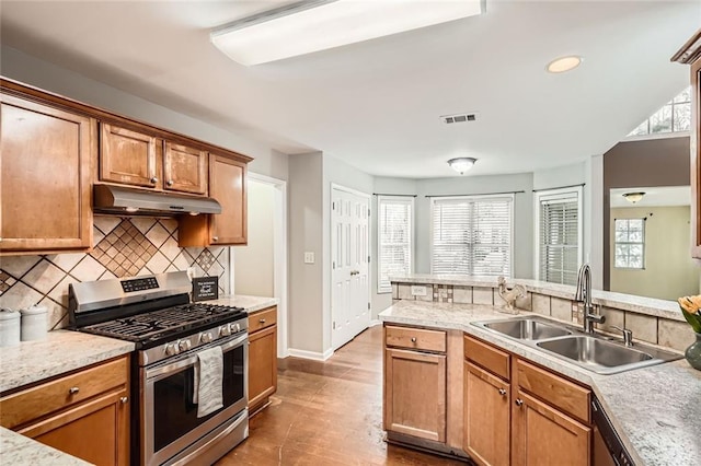 kitchen with backsplash, sink, and appliances with stainless steel finishes