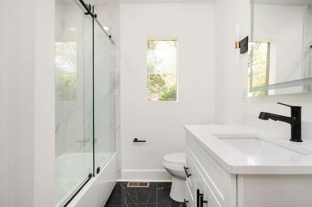 bathroom featuring baseboards, toilet, enclosed tub / shower combo, visible vents, and vanity