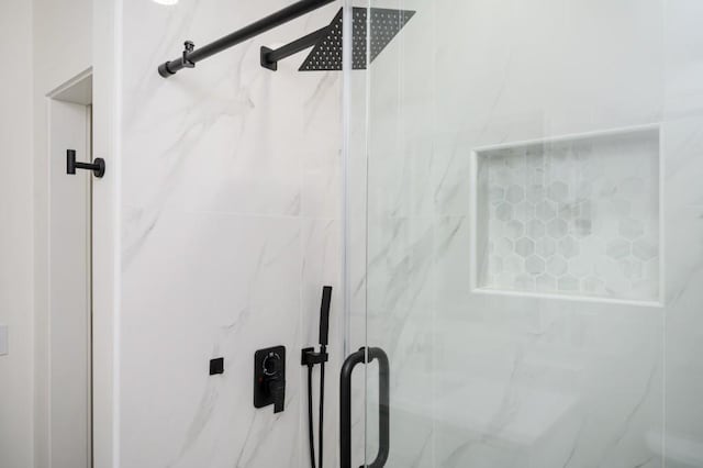 details featuring a marble finish shower
