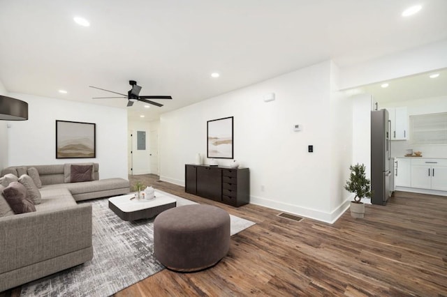 living area featuring visible vents, baseboards, ceiling fan, dark wood-style floors, and recessed lighting