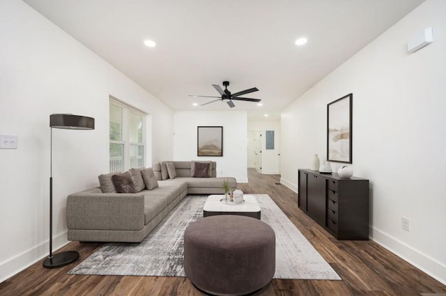 living room featuring baseboards, wood finished floors, a ceiling fan, and recessed lighting