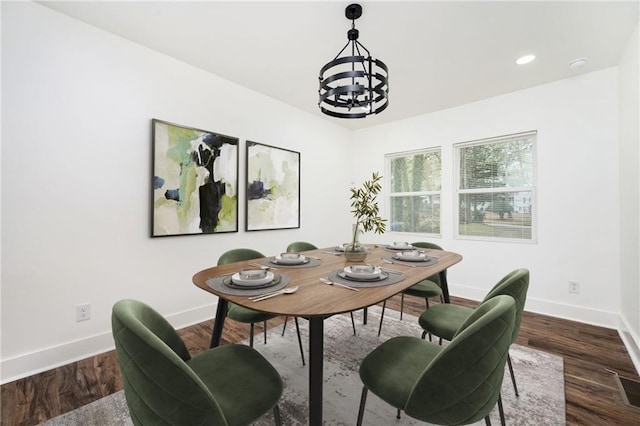 dining room with an inviting chandelier, recessed lighting, baseboards, and wood finished floors