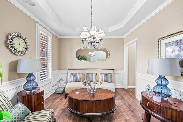7731 Sleepy Lagoon Way, Flowery Branch, GA 30542 - living area featuring a chandelier, wood finished floors, a tray ceiling, a wainscoted wall, and crown molding