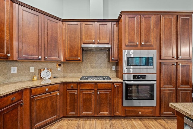 7731 Sleepy Lagoon Way, Flowery Branch, GA 30542 - kitchen featuring stainless steel appliances, light wood-type flooring, tasteful backsplash, and light stone counters