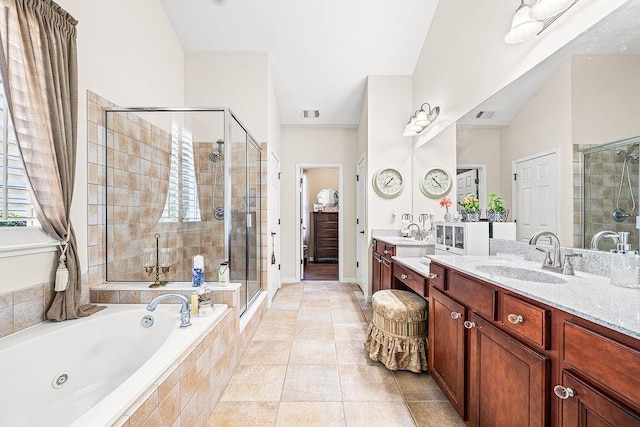 7731 Sleepy Lagoon Way, Flowery Branch, GA 30542 - full bathroom with a shower stall, a jetted tub, vanity, and tile patterned flooring