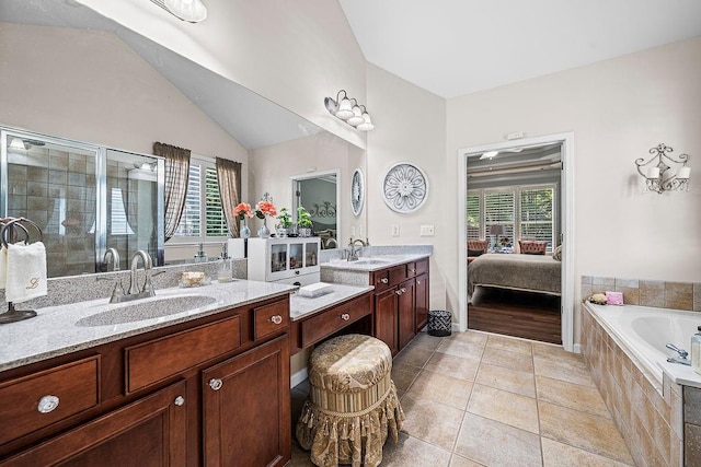 7731 Sleepy Lagoon Way, Flowery Branch, GA 30542 - ensuite bathroom with healthy amount of natural light, a stall shower, vanity, and lofted ceiling