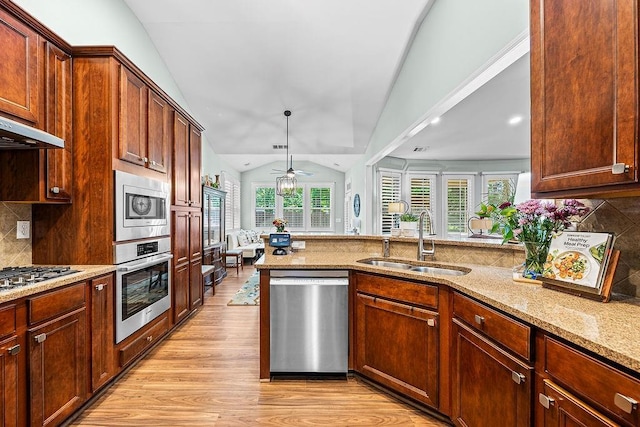 7731 Sleepy Lagoon Way, Flowery Branch, GA 30542 - kitchen featuring stainless steel appliances, lofted ceiling, light wood-style flooring, light stone countertops, and ceiling fan