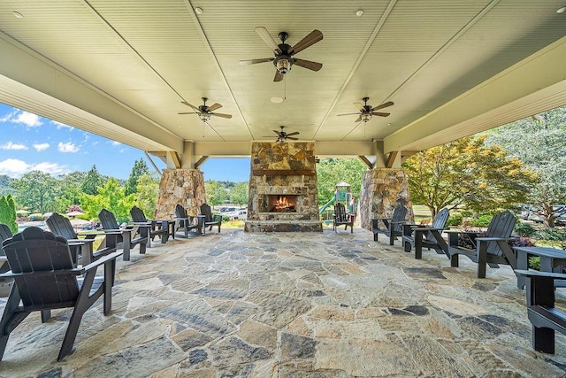 7731 Sleepy Lagoon Way, Flowery Branch, GA 30542 - view of patio with an outdoor stone fireplace and a ceiling fan