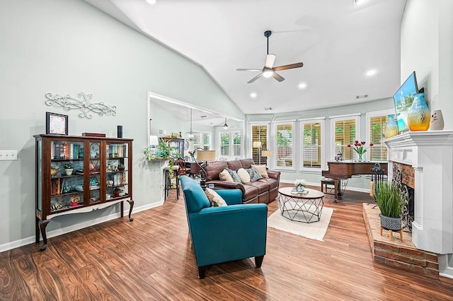 7731 Sleepy Lagoon Way, Flowery Branch, GA 30542 - living room featuring a ceiling fan, vaulted ceiling, wood finished floors, a fireplace, and recessed lighting