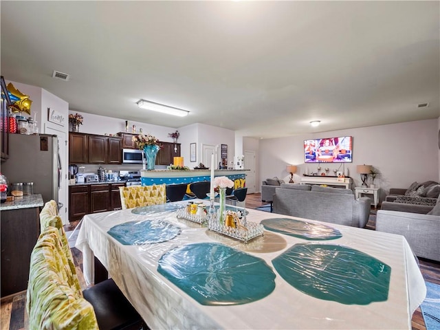 dining area with hardwood / wood-style floors