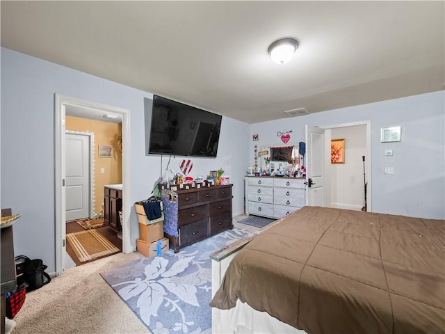 carpeted bedroom with connected bathroom