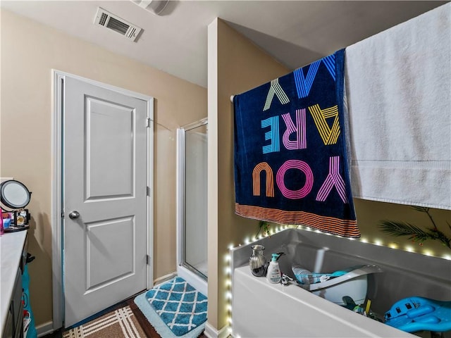 bathroom featuring vanity and an enclosed shower