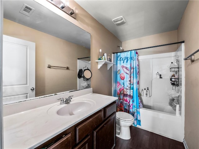 full bathroom featuring toilet, hardwood / wood-style flooring, shower / bathtub combination with curtain, and vanity