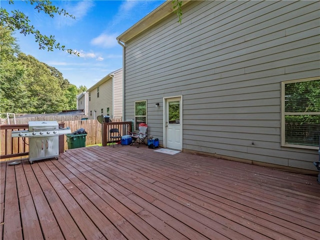 wooden deck featuring a grill