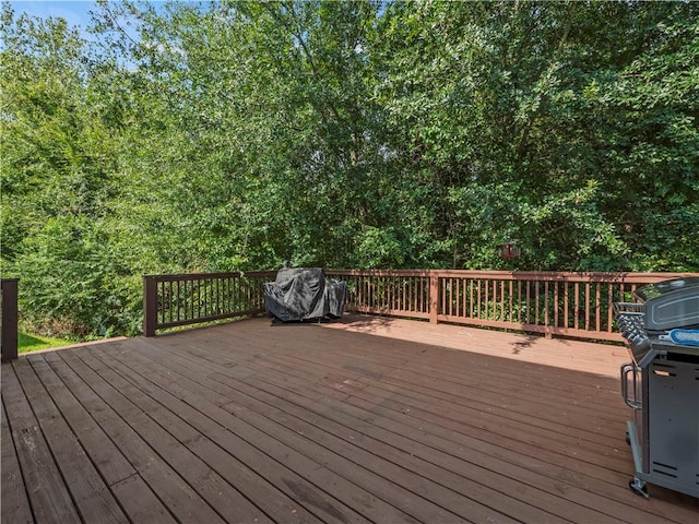 wooden terrace with a grill