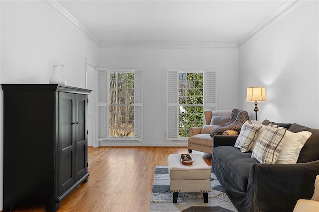 living area featuring crown molding and light wood finished floors