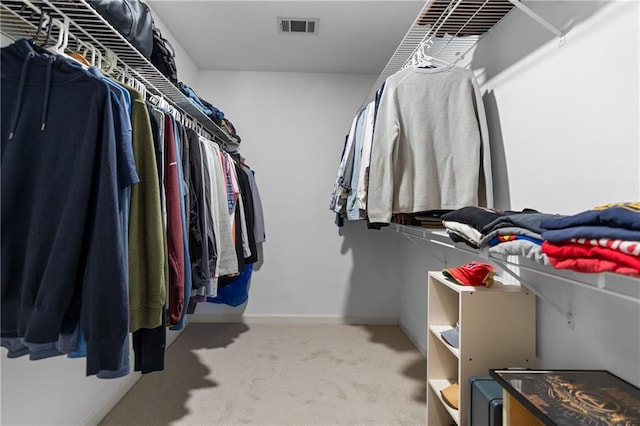 walk in closet with visible vents and carpet flooring