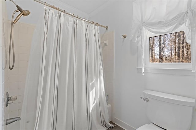 bathroom with toilet, shower / bath combo, and ornamental molding