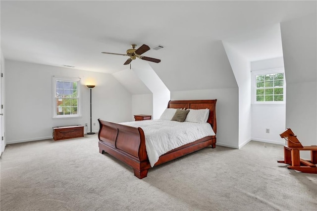 carpeted bedroom with ceiling fan, visible vents, baseboards, and vaulted ceiling