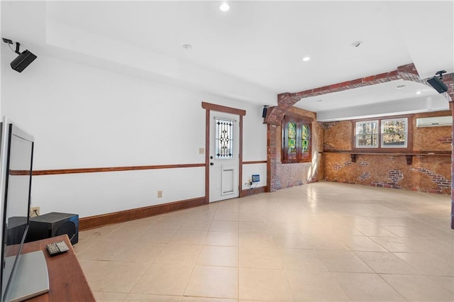 interior space featuring recessed lighting, baseboards, and a wall mounted AC