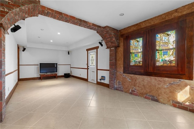 unfurnished living room featuring recessed lighting, tile patterned floors, and baseboards