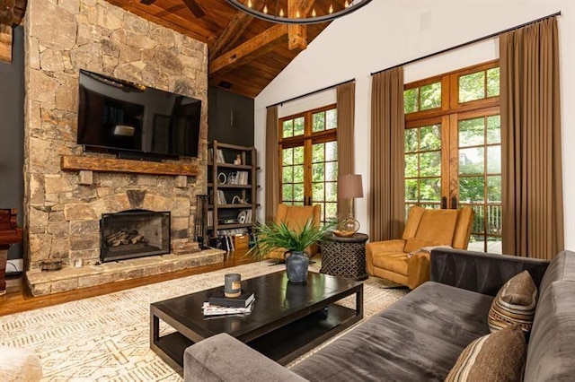 living room featuring high vaulted ceiling, wooden ceiling, a fireplace, french doors, and beamed ceiling