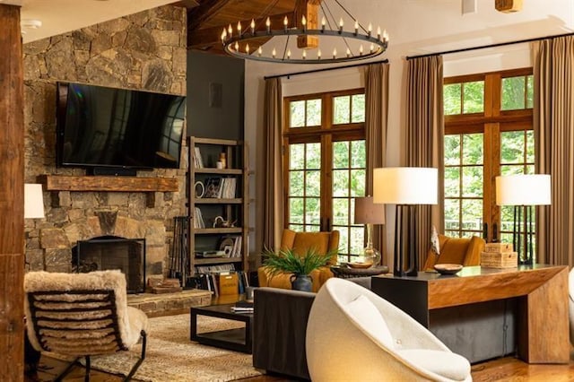 living area with an inviting chandelier, a fireplace, a wealth of natural light, and french doors
