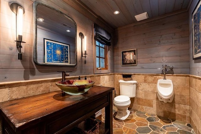 half bath featuring wooden ceiling, toilet, recessed lighting, a wainscoted wall, and vanity