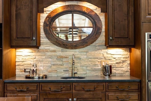 bar with wet bar, backsplash, and a sink