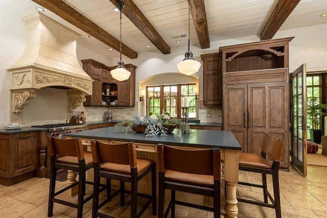 kitchen featuring dark countertops, custom exhaust hood, open shelves, and backsplash