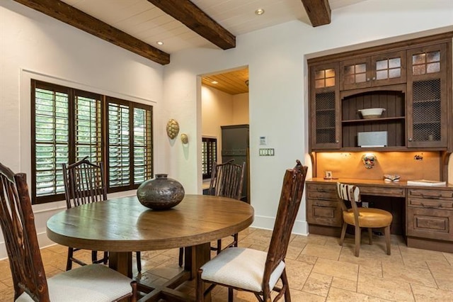 dining space with recessed lighting, baseboards, built in study area, beamed ceiling, and stone tile flooring