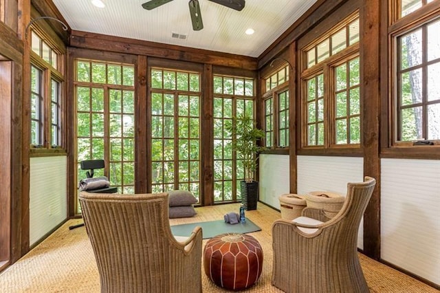 sunroom / solarium with a ceiling fan and visible vents
