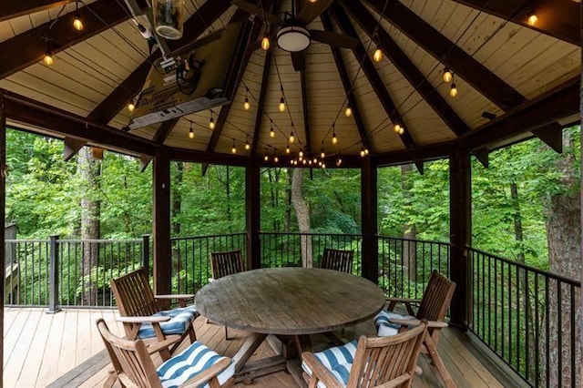 wooden deck with outdoor dining area and a gazebo