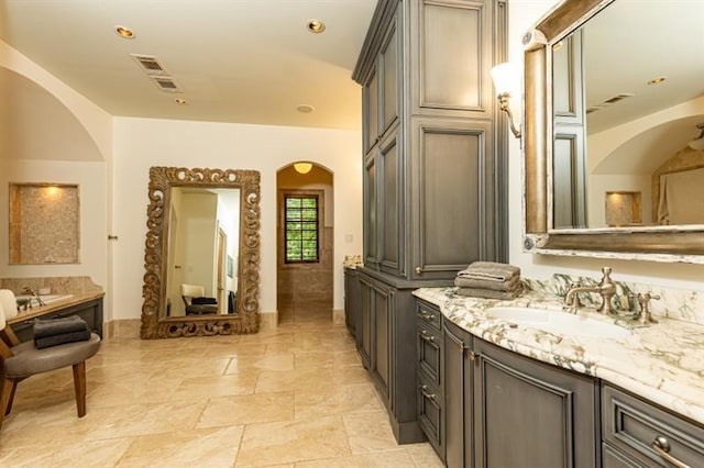 full bath with visible vents, vanity, a bathing tub, and recessed lighting