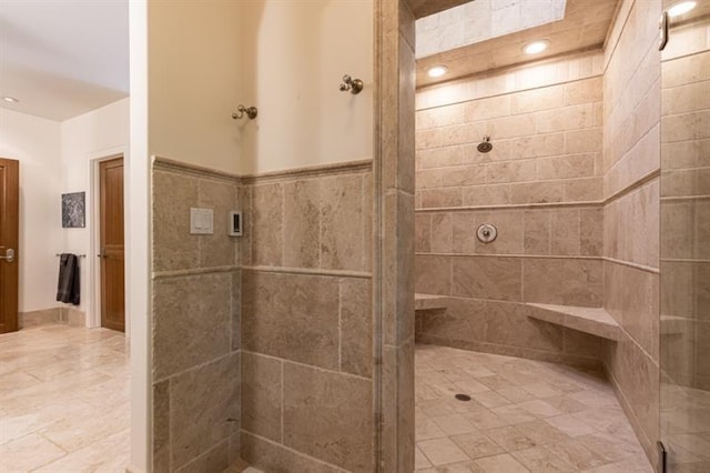 full bath with tiled shower and recessed lighting