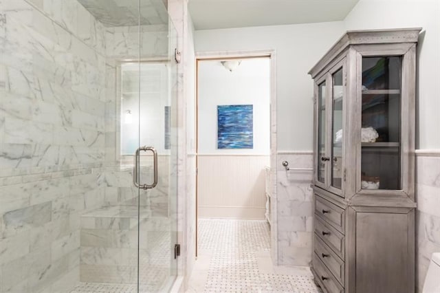 bathroom with a stall shower and wainscoting