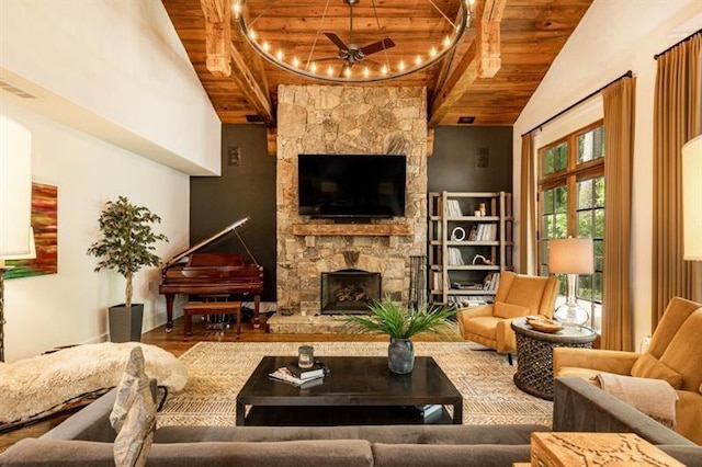 living room with a ceiling fan, lofted ceiling with beams, wooden ceiling, wood finished floors, and a fireplace