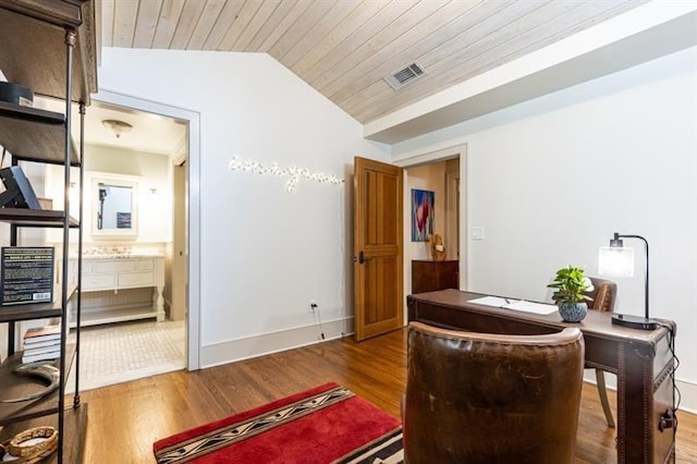 office area featuring baseboards, visible vents, wooden ceiling, wood finished floors, and vaulted ceiling