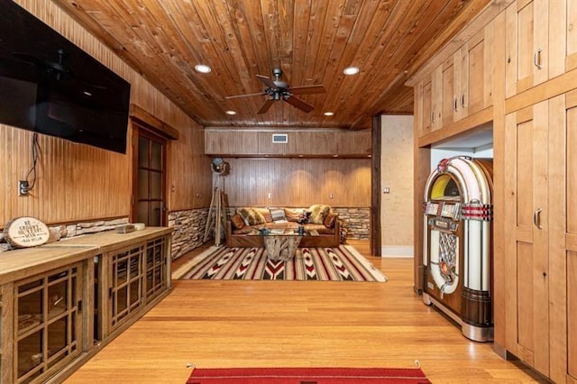 wine room with recessed lighting, visible vents, wood walls, wood finished floors, and wooden ceiling