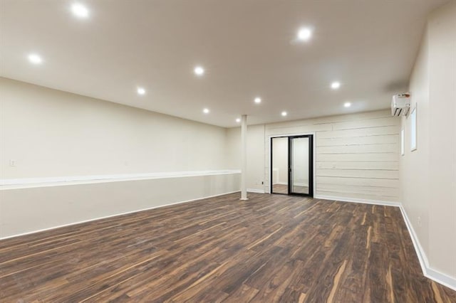 spare room with recessed lighting, a wall mounted AC, and wood finished floors