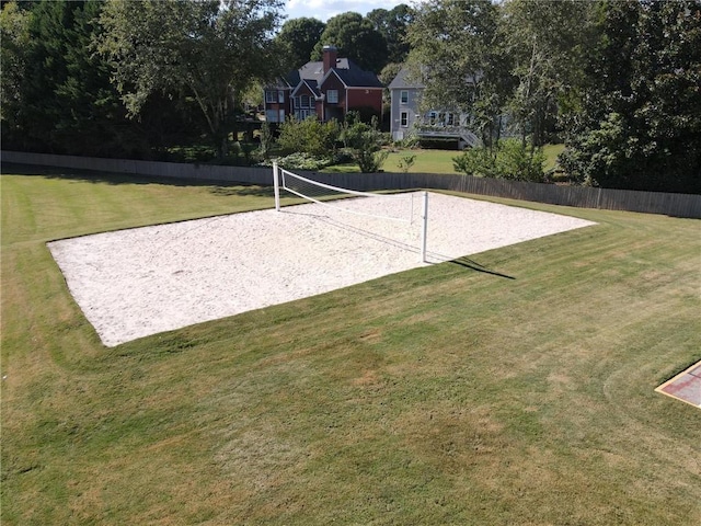 view of property's community with volleyball court and a yard