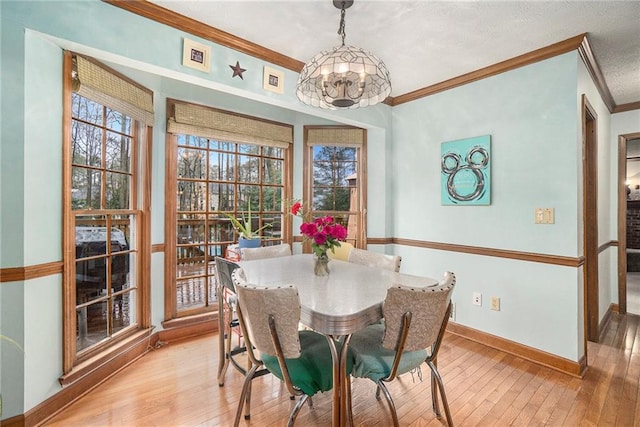 dining area featuring crown molding and light wood-type flooring