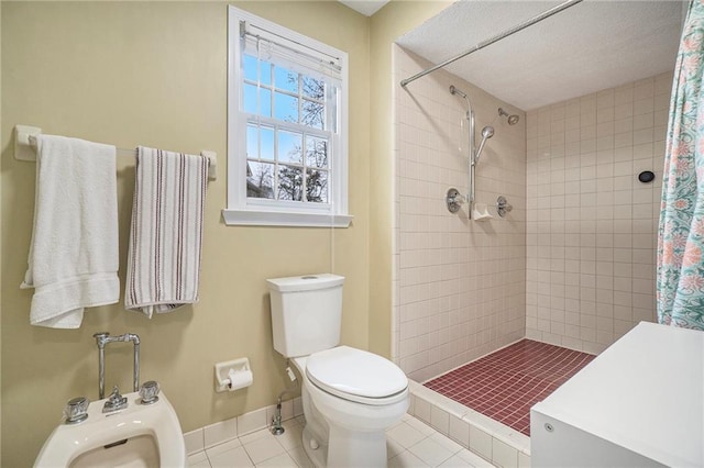 bathroom featuring a bidet, a shower with curtain, tile patterned floors, and toilet