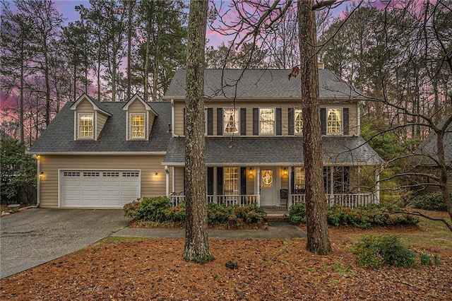 view of front of house featuring a garage and a porch