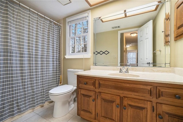 bathroom featuring vanity, tile patterned floors, and toilet