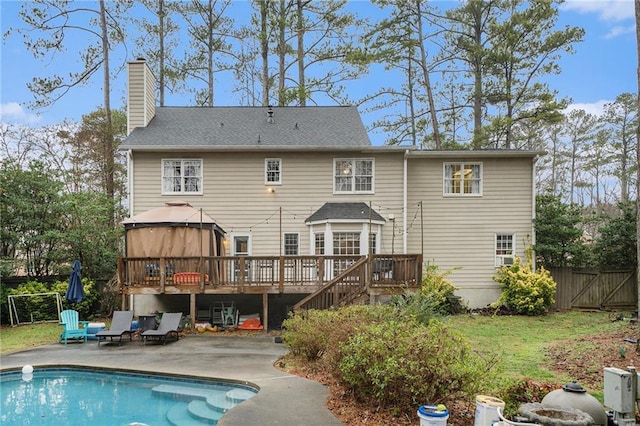 back of property featuring a gazebo, a pool side deck, and a patio area