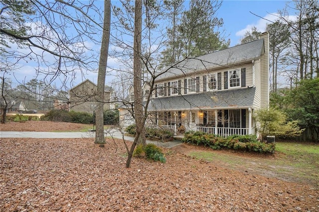 rear view of property featuring a porch