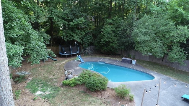 view of swimming pool featuring a trampoline