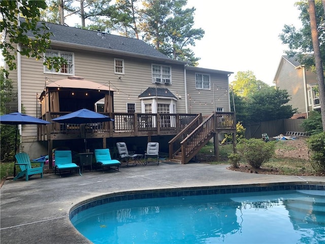 rear view of property featuring a patio and a swimming pool side deck