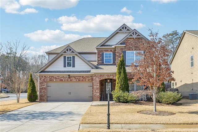 craftsman inspired home with cooling unit and a garage